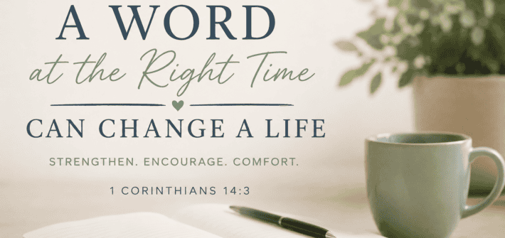 A Word at the Right Time Can Change a Life - 1 Corinthians 14:3 A muted text based image of a bible open on a table top along with a coffee cup and a green potted plant.