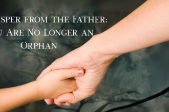 A child's hand reaching out to the hand of a father.