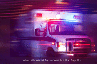 Ambulance speeding down a street in the middle of the night.
